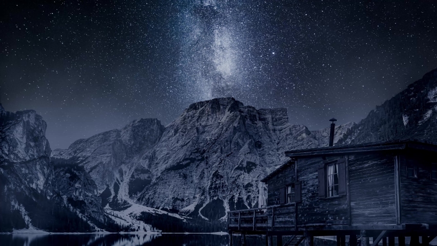 Timelapse of milky way over Lago di Braies, Dolomites. Wildlife at night in Italian mountains.