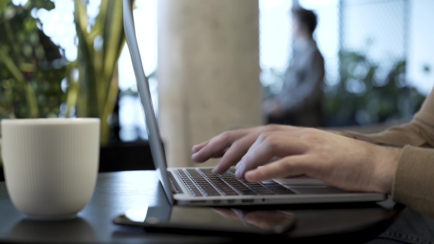 Businessman hits the enter key to send completed file, do upload action, finish work project, send letter, save file or do another concluding action.