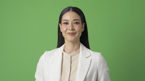Portrait of beautiful business at green screen background. She clapping her hand and smile.