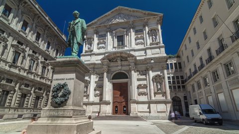 San Fedele Church with Alessandro Manzoni Statue timelapse hyperlapse, important Italian writer and poet of the nineteenth century, Milan city center, Italy. Blue sky at summer day
