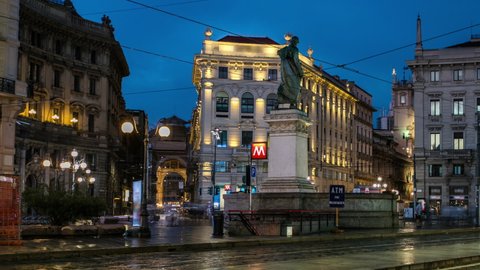 Cordusio Square and Dante street with surrounding palaces, houses and buildings day to night transition panoramic timelapse in Italian capital of fashion and luxury. Monument to writer and poet