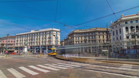 Cordusio Square and Dante street with surrounding palaces, houses and buildings timelapse hyperlapse in Italian capital of fashion and luxury. Trams passing by. Monument to writer and poet Giuseppe