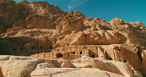 PETRA - Jordan's most-visited tourist attraction. Historic and archaeological Red Rose City with rock-cut architecture with caves and tombs carved into a stone cliff. 4K reveal gimbal shot