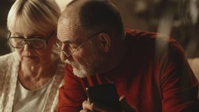 Tilt down and tilt up view of senior husband and wife talking and calculating utility payment over table together in evening at home - Powered by Shutterstock - Get 15% off with code: PIKWIZARD15