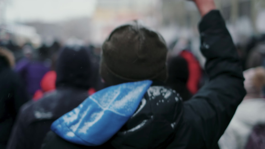 Peaceful Russian protesters marching on streets of Moscow. Unarmed non-violent activists on political rally, opposition riot. Picketing crowd chanting “Let him go!”, walks with smartphones in hands. | Shutterstock HD Video #1088174943