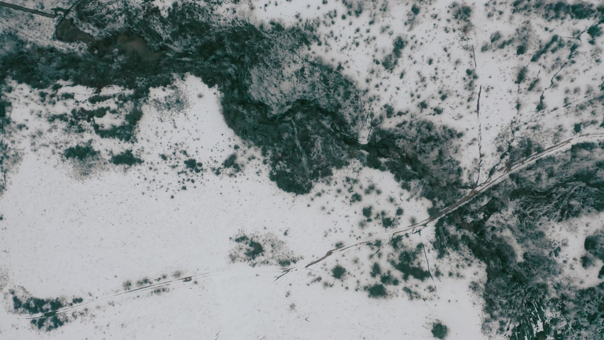 Aerial drone fly over snowy mountains at midday. Beautiful Landscape view of Stara Planina Bulgaria at winter snow covered rocks and hills.