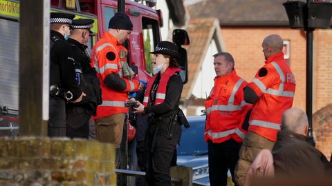 Norwich, Norfolk, United Kingdom. March 9, 2022. Police officers and firefighters equip female police officer with lifejacket before she boards the fire rescue boat.