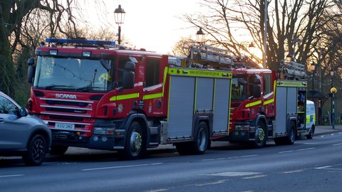 Norwich, Norfolk, United Kingdom. March 9, 2022. Two Scania fire engines from Carrow and Earlham  fire stations in Norwich parked by the road at sunset, Thorpe River Green.