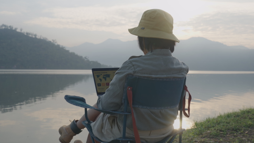 Asia people young adult woman enjoy get away relax feet up sit on chair learn MBA online 5G wifi on laptop. Anywhere hybrid workspace at outdoor rural dawn sunrise sky scene for future job workforce. | Shutterstock HD Video #1088178047