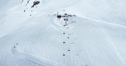 Aerial drone view of a ski lift arrival in the Alps, Moutains in Savoie, France 