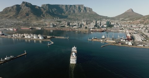 Spectacular aerial view of a cruise ship entering Cape Town Harbour, Table Mountain and City Centre in the background,Cape Town, South Africa. Travel and tourism