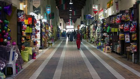 KUWAIT CIRCA 2013 - People walking fast in a shopping street during the day in Kuwait City.