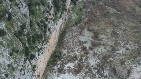 Drone shooting of Rocche del Crasto in winter, a mountainous and rocky complex where the golden eagle nests, Nebrodi, Sicily, Italy. Typical villages set between the fortresses. Longi and Alcara.