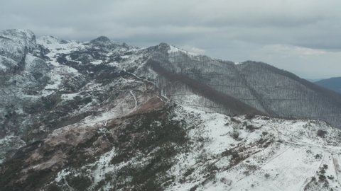 Drone shooting of Rocche del Crasto in winter, a mountainous and rocky complex where the golden eagle nests, Nebrodi, Sicily, Italy. Typical villages set between the fortresses. Longi and Alcara.
