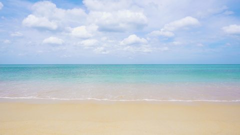  Long beach waves gently lapping shoreline summer. Beach space area white clouds background.  Sea nature white sand with blue sky.