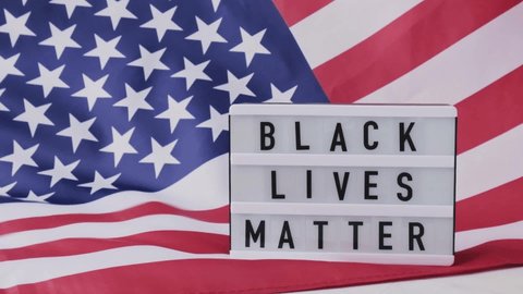 Slow motion Waving American Flag Background. Lightbox with text BLACK LIVES MATTER Flag of the united states of America. July 4th Independence Day. USA patriotism national holiday. Usa proud.