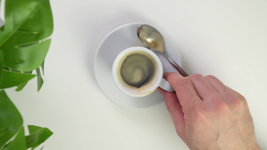 Stir the hot coffee in a cup with a spoo, Stock Video