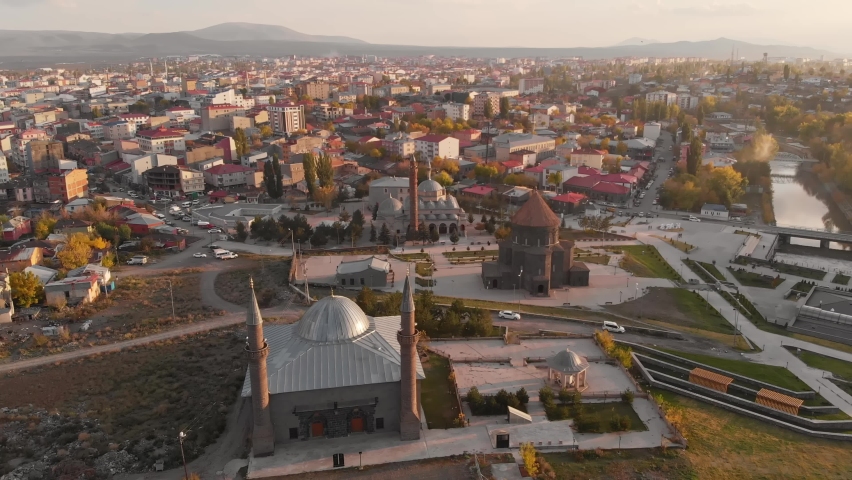 Top view cityscape of Kars city at sunset in Kars province, Eastern Anatolia, Turkey. Castle of Kars, Beylerbeyi Palace, Ulu cami and other landmarks. Aerial drone footage 