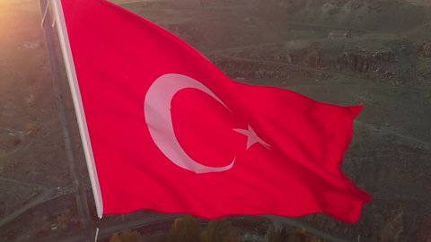 Flag of Turkey waving in the wind. Flying around Turkish flag close-up. Turkish national flag in sunset sunlight close-up.