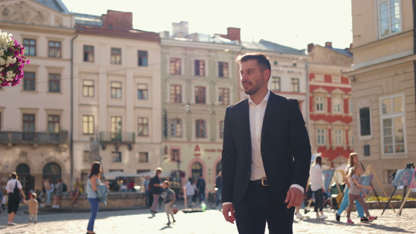 Feeling relaxed. Elegant experienced adult caucasian businessman in suit is walking at the street and looking thoughtfully while spending his break Royalty-Free Stock Footage #1088188775