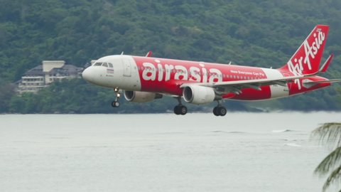 PHUKET, THAILAND - DECEMBER 02, 2016: Airbus A320, HS-BBC of AirAsia landing at Phuket Airport (HKT). AirAsia Malaysian low cost airline. Tourism and travel concept