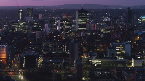 Establishing Aerial View Shot of Manchester UK, England United Kingdom at night evening, city center busy evening