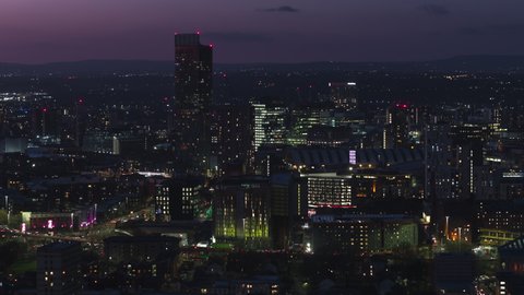 Establishing Aerial View Shot of Manchester UK, England United Kingdom at night evening city center busy roads