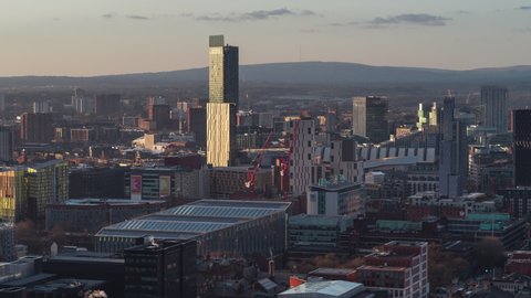 Establishing Aerial View Shot of Manchester UK, England United Kingdom, sunset rays, city center