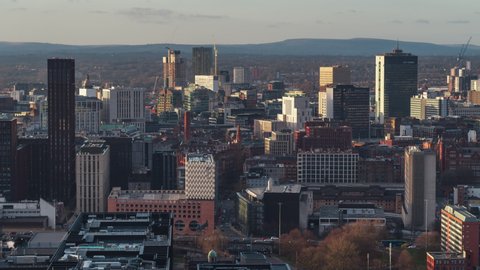 Establishing Aerial View Shot of Manchester UK, England United Kingdom, city center, traffic, gold