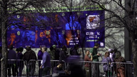Austin, Texas March 13, 2022: People wait in line to get into a music venue during SXSW 2022 in Austin Texas