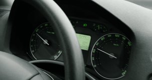 Handheld video of car driving with 60km per hours on street focus on the dashboard with digital simple dot matrix display screen