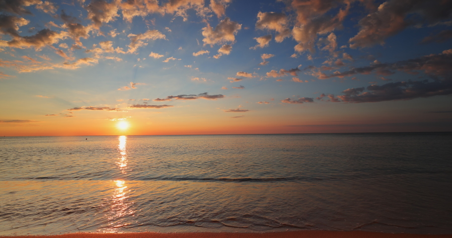 Beautiful sunrise over the sea and beach. Sunset over ocean waves.