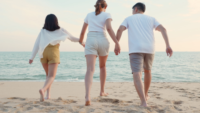 Happy friends holding hands running enjoy life funny and freedom on sand at beach together to sea in holiday vacation time at sunset, Young Asian group woman and man in summer travel, people lifestyle Royalty-Free Stock Footage #1088192257