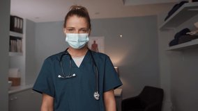 Caucasian female nurse standing with arms crossed 