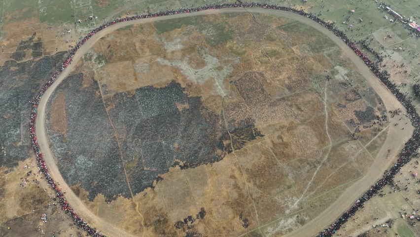 Aerial view of many people watching traditional horse race in Mohanpur, Bangladesh.