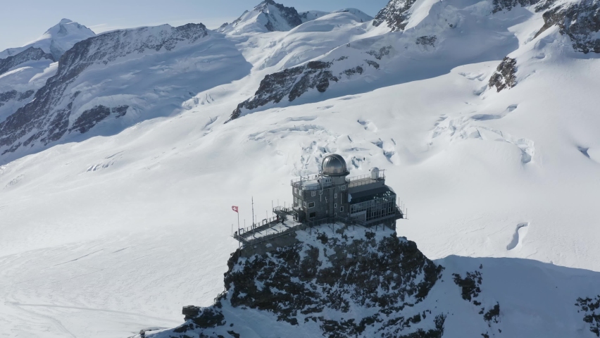 Aerial view of Jungfraujoch, a building on mountain crest with snow on Swiss Alps, Wengen, Bern, Switzerland.