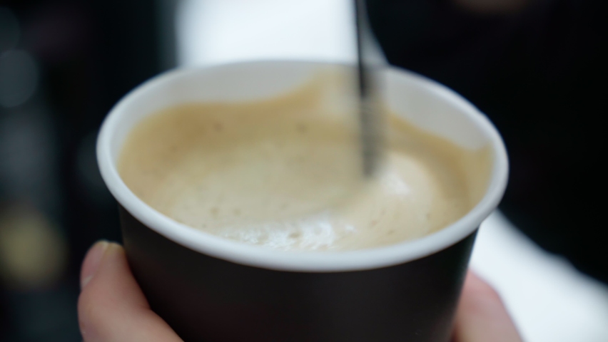 Coffee with foam mixed with a wooden stick, in a disposable paper cup. Ecology, no plastic. Close-up. Selective focus | Shutterstock HD Video #1088207387