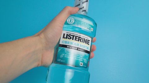 Tyumen, Russia-February 06, 2022: Listerine Cool Mint Mouthwash are clinically shown. Blue background