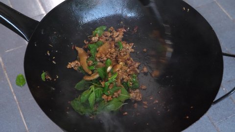 Holy basil minced pork stir fry. Pad Gaprao is one of the most favorite thai food. Holy basil stir fry in 4K.