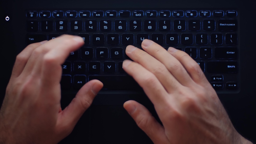 Flat lay video of freelance it specialist coding on modern laptop computer with backlit keyboard. Hands of freelancer programmer working overtime at night on notebook pc. 4k stock video | Shutterstock HD Video #1088209219