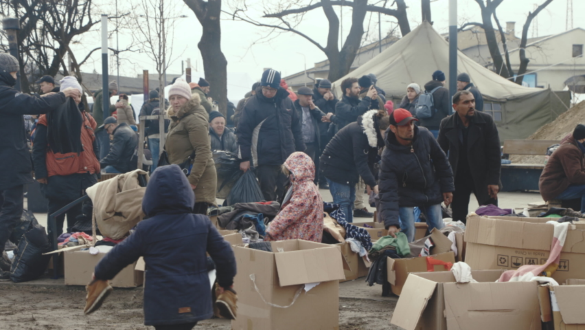 Lviv, Ukraine - March 15, 2022: Humanitarian aid. Crowd of refugees at the train station unload the aid that came from Europe. War at Ukraine concept. War with Russia at Ukraine