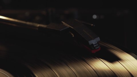 A needle on a vintage vinyl record. vinyl records are spinning The needle plays on an antique vinyl record. Old turntable.