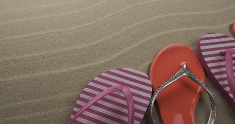 Rotation of beach flip flops standing on sand dunes. With space for design, text place. Copy space.