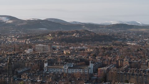Establishing Aerial View Shot of Edinburgh UK, Scotland United Kingdom, stunning cityscape with mountain view