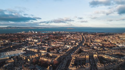 Establishing Aerial View Shot of Edinburgh UK, Scotland United Kingdom, super wide, golden light, sea side
