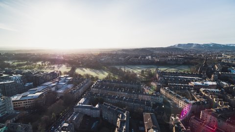 Establishing Aerial View Shot of Edinburgh UK, Scotland United Kingdom, sun welcomes old city, large park