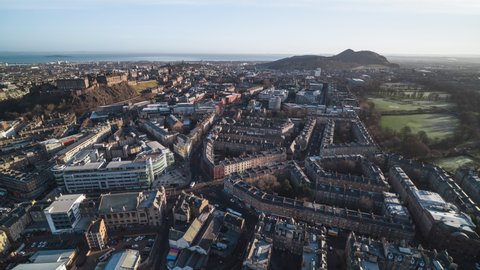 Establishing Aerial View Shot of Edinburgh UK, Scotland United Kingdom, Wide view of old town and near mountains