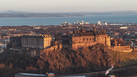 Establishing Aerial View Shot of Edinburgh UK, Scotland United Kingdom, fabulous golden light on the iconic Edinburgh Castle