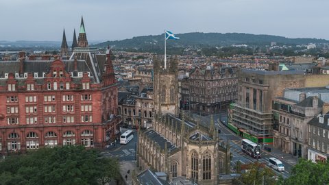 Establishing Aerial View Shot of Edinburgh UK, Scotland United Kingdom, Scottish Flag on the church