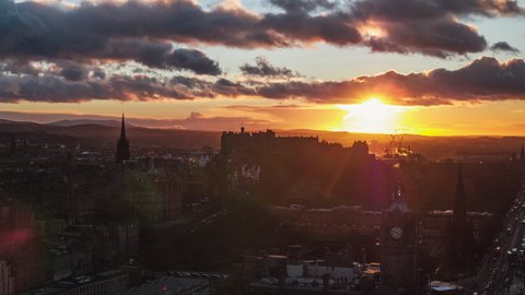 Establishing Aerial View Shot of Edinburgh UK, Scotland United Kingdom, sunset over Edinburgh Castle